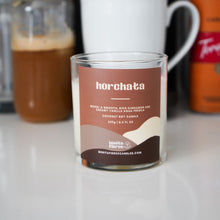 Load image into Gallery viewer, Jar of horchata on a kitchen counter with coffee-making equipment in the background
